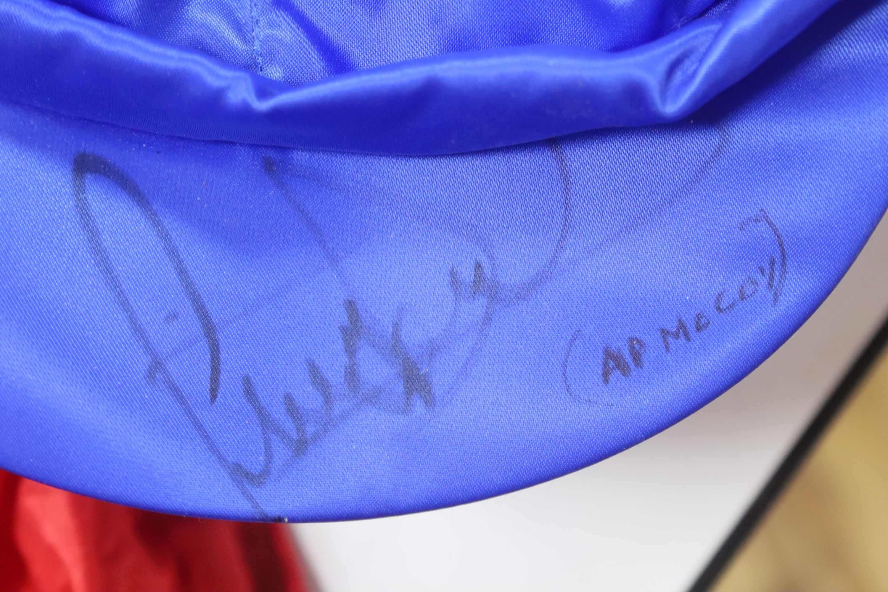 Two A.P. McCoy signed silk caps